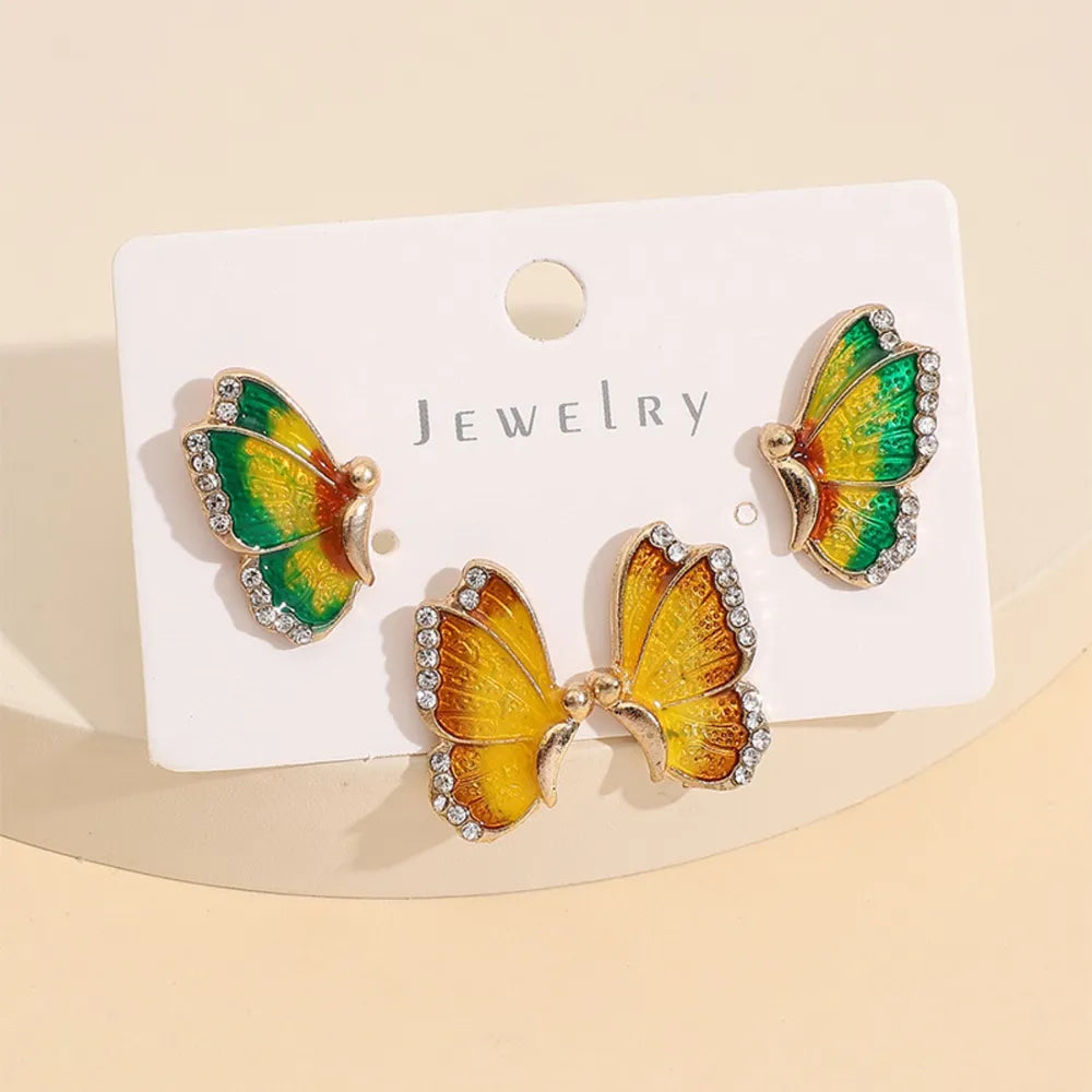 Butterfly-shaped earrings on a jewelry card with a beige background